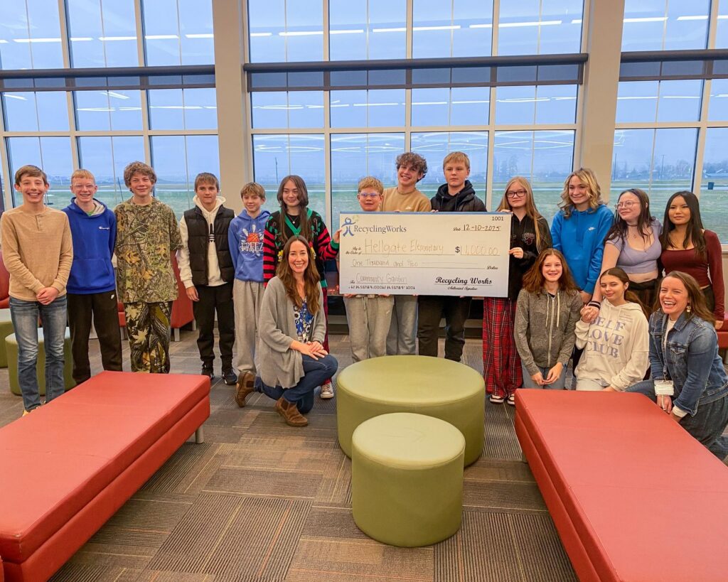 Recycling Works presenting $1,000 GiveBack Grant donation in the form of a big check to Hellgate Elementary Community Garden, December 2025.