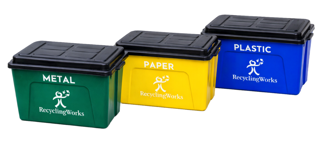 Three curbside recycling bins labeled metal, paper, and plastic used for residential recycling services in Missoula by Recycling Works